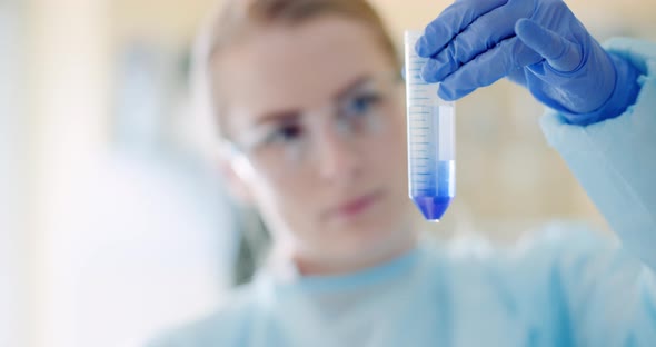 Scientist Mixing Liquid in Laboratory While Working on DNA