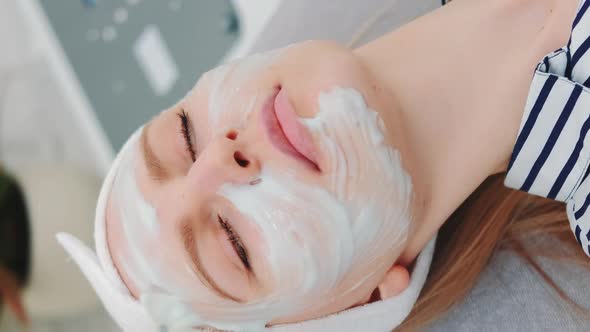 Medium Shot of Beautician Putting Cream Mask on Woman's Face at Beauty Salon