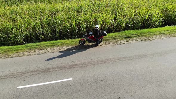 Motorcycle Riding By Country Road on Sunset, Beautiful Adventure Travel Footage Shot From Drone, Top