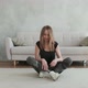 female sits on floor in lotus position with her artificial leg bent and relaxes - VideoHive Item for Sale