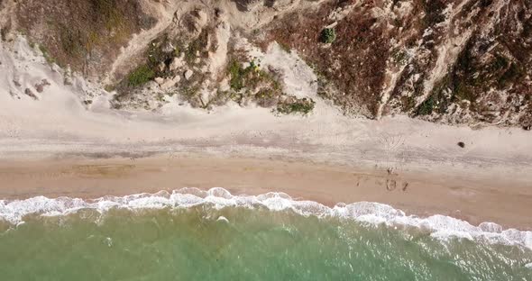 Top Down View of Waves Breaking in the Sand, Flying Over Tropical Sandy Beach and Waves