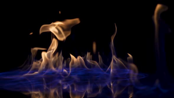 Flammable Liquid Catches Fire and Burns on Black Studio Background