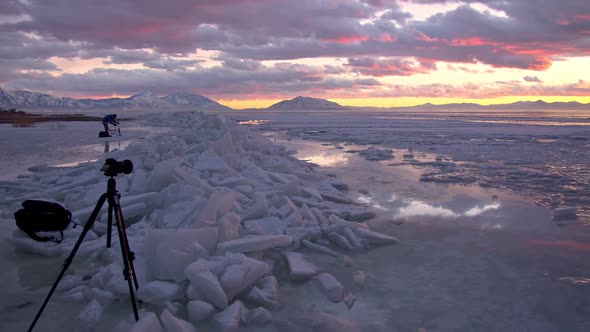 Panning the winter landscape with stacks of ice on Utah Lake viewing tripods