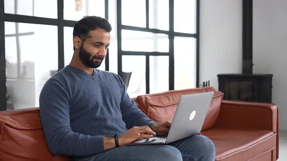 Clever Indian Freelancer Using Laptop for Remote Work From Home