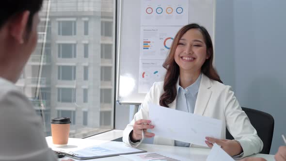 Happy beautiful business woman talking and laughing at the meeting in office