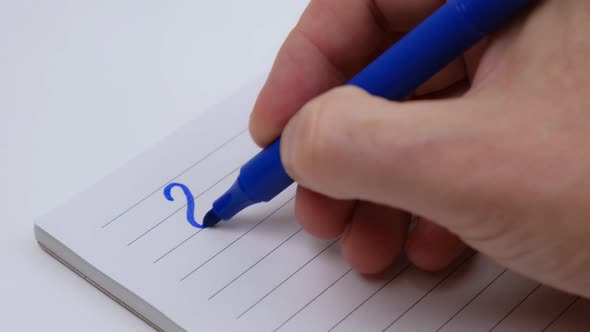 man's hand writes the numbers of 2023 with a blue felt-tip pen in a notebook. selective focus. 4k.