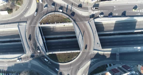 Top down view round road junction in the center. Circle road on two levels. Street traffic