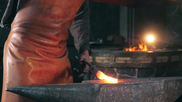 Smithy Worker Is Beating Heated Metal with a Hammer