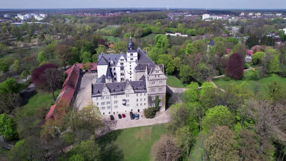 Schloss Wolfsburg castle, Germany, Tilt up aerial view on very sunny day