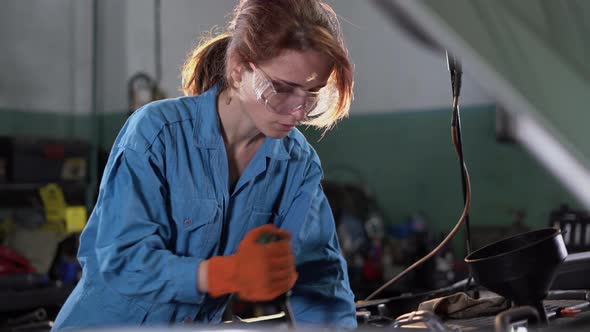 Portrait of a Woman Mechanic Working in a Car Service