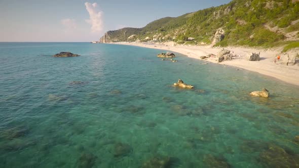 Aerial view of the beach shore with small rocks embedded around in Lefkas island