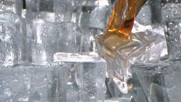 Whisky Is Pouring Onto Ice Cubes In A Glass In Slow Motion Camera Dollying Out