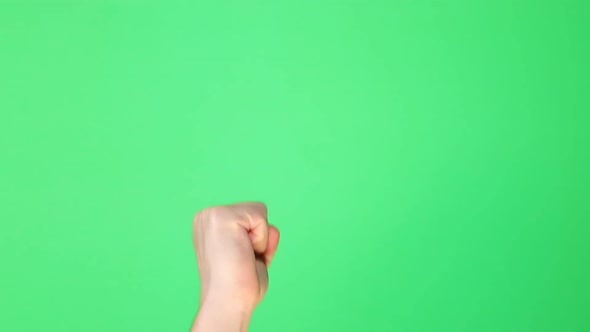 Male hand knocking on green background