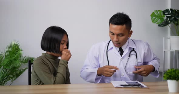 Doctor using stethoscope listen to the heart of girl in the clinic