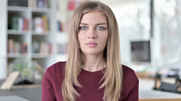 Portrait of Attractive Young Woman Looking at Camera