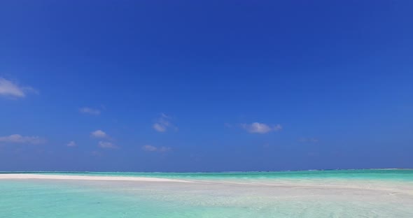 Luxury birds eye island view of a sandy white paradise beach and aqua blue ocean background in color