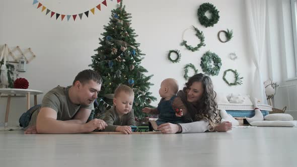 Family of Four Spending Time Over Christmas Tree