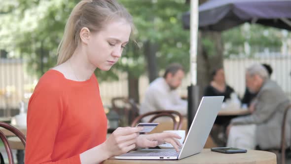Successful Online Shopping By Young Woman Sitting on Bench