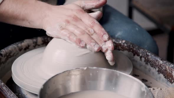 Adult Sculptor Working with Raw and Wet Clay in Workshop Room