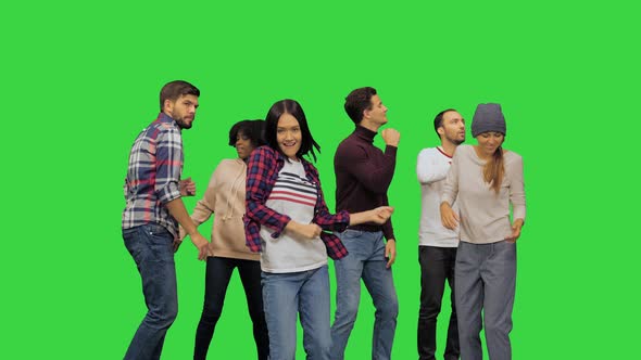Young Lively Beautiful Girl Dancing with the Others at the Party on a Green Screen Chroma Key