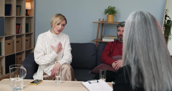Crop View of Married Couple Sharing Family Problems with Female Psychologist