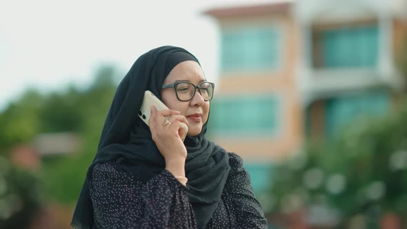 good looking Muslim women sitting outside working according to the slogan work form home