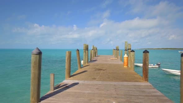 Aerial drone view of a dock pier on a tropical island beach and coast in the Bahamas, Caribbean. 