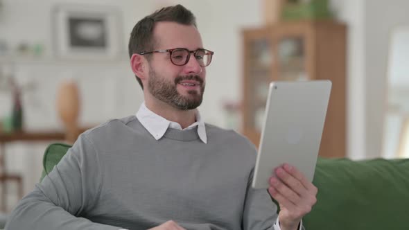 Middle Aged Man Doing Video Chat On Tablet