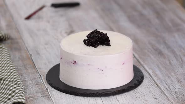 Confectioner Decorates Cake with Blackcurrant Jam