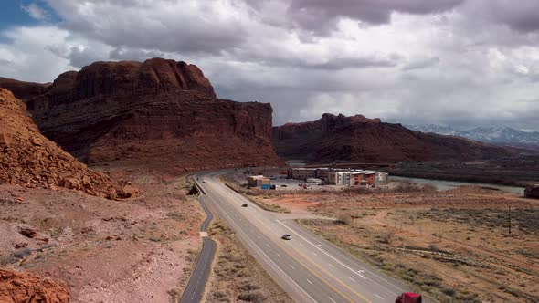 Entering Moab Utah along Highway 191 on a cloudy day, aerial