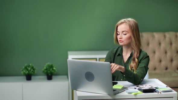 Focused Young Business Woman Working Remotely on Laptop Pc
