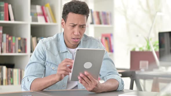 Young African American Man Disappointed By Loss on Tablet Failure