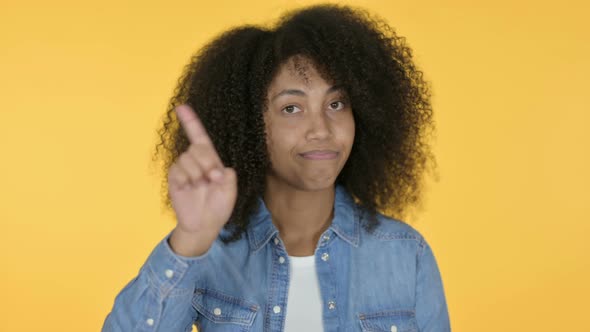 African Woman No Sign By Finger, Yellow Background 