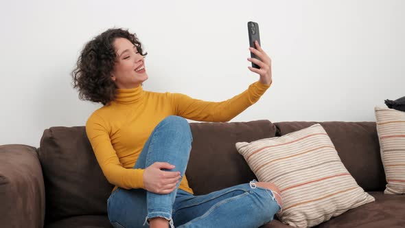 Smiling Hispanic Curly Woman Blogger Greets Talking Online Video Call Smartphone