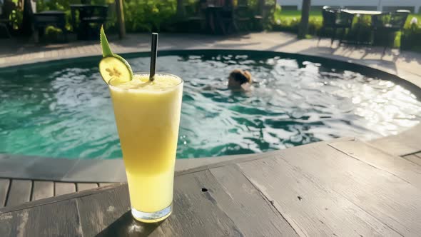 Closeup Delicious Tropical Juice with Slice of Lime on Glass at Beautiful Terrace Restaurant with