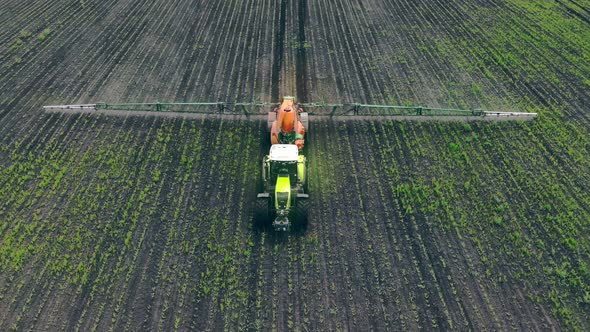 Aerial View Farm Machinery Spraying Insecticide To the Green Field, Agricultural Natural Seasonal