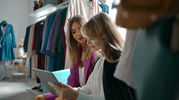 Woman Asking Friend for Advice During Online Shopping