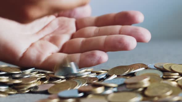 Man's Hands Holding Lots of Coins