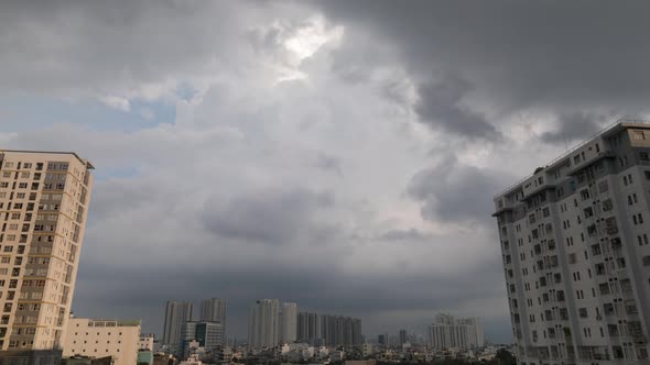 Heavy tropical storm developing over residential area with high rise buildings framing the sky time