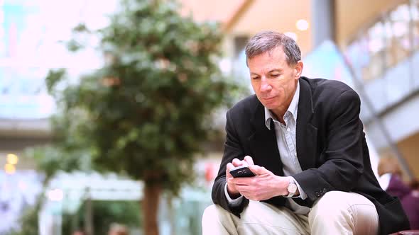 Businessman using smart phone in the city