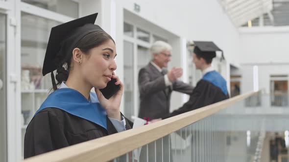 Cheerful Female Graduate Having Phone Call