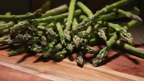 Fresh Green Asparagus Falls on a Wooden Board