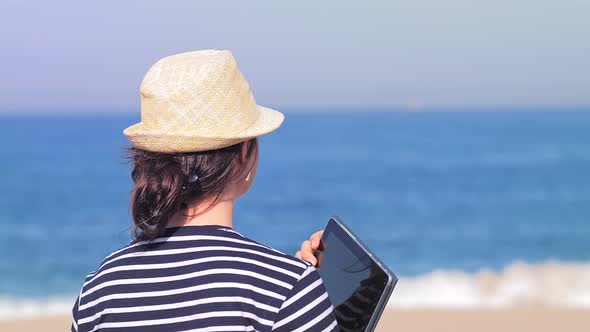 Traveling Woman in Straw Hat on Beach Using Laptop on Holidays