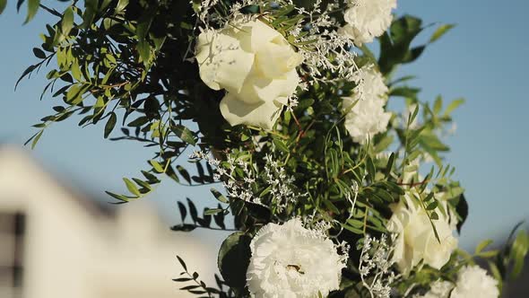 Wedding Arch With Fresh Flowers on Summer Sunny Wedding Day