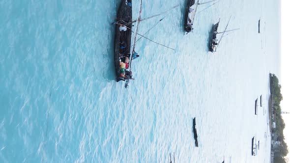 Vertical Video Boats in the Ocean Near the Coast of Zanzibar Tanzania Aerial View