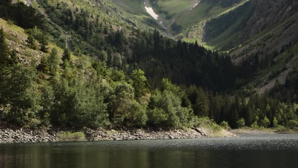 Detail pan-up shot of a beautiful lake in the Alps up to the alpine mountain peaks of the glacier in