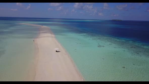 Aerial top down sky of relaxing tourist beach adventure by blue water and white sand background of a