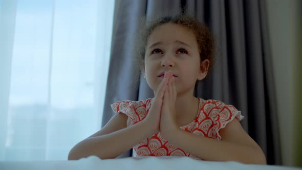 Little Girl is Praying in Her Room