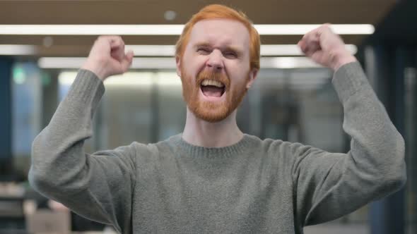 Portrait of Excited Young Man Celebrating Success