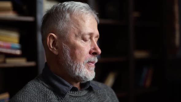 Closeup Face of Bearded Mature Adult Male Talking By Digital Tablet with Family Sitting at Home